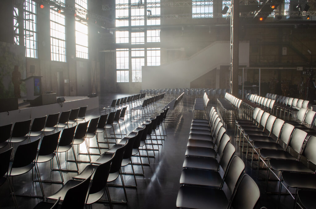 Black row seating in a light-filled industrial building